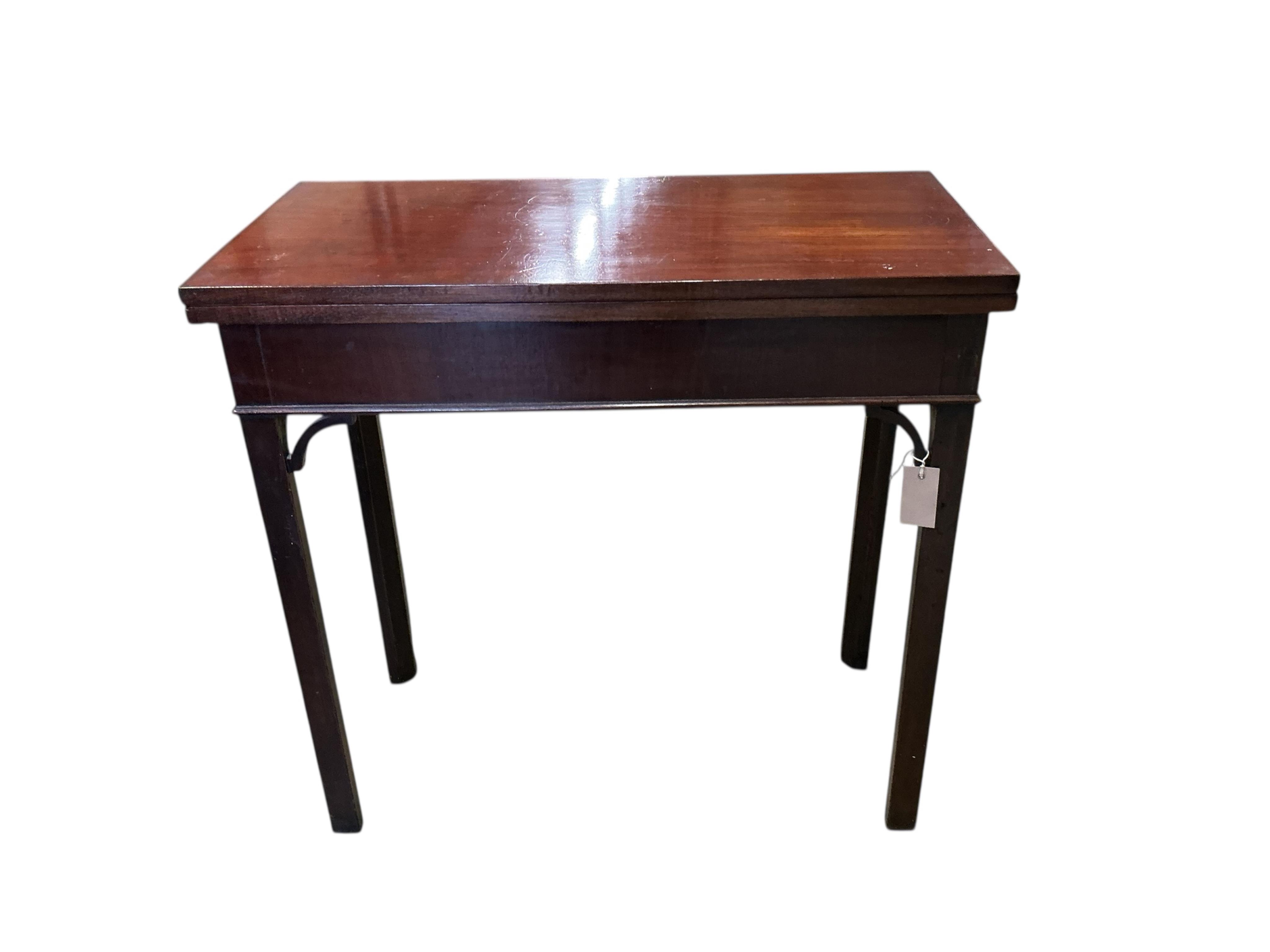 A small George III rectangular mahogany folding card table, width 76cm, depth 37cm, height 73cm